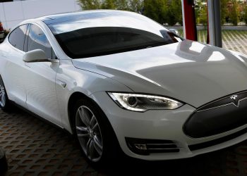 A Tesla Motors Inc. Model S vehicle is charged at company's design studio in Hawthorne, California, U.S., on Wednesday, July 31, 2013. The Tesla Model S led sales in the plug-in hybrid electric and electric vehicle market segments with an estimated 23.7% of the segments and 3.6% of the entire hybrid market. Photographer: Patrick T. Fallon/Bloomberg via Getty Images